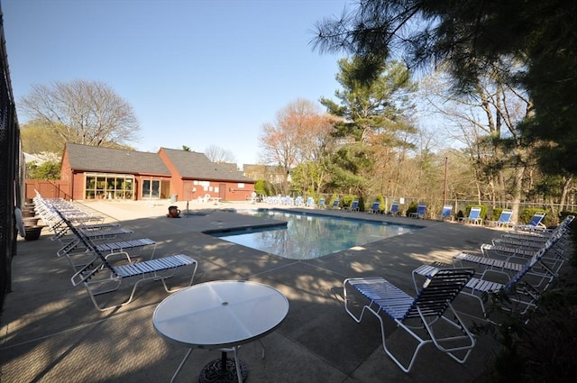 pool with fence and a patio