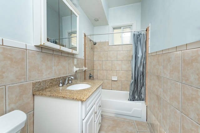 full bathroom featuring tile patterned flooring, toilet, tile walls, shower / bath combination with curtain, and vanity