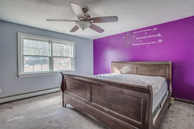 carpeted bedroom with ceiling fan and a baseboard heating unit