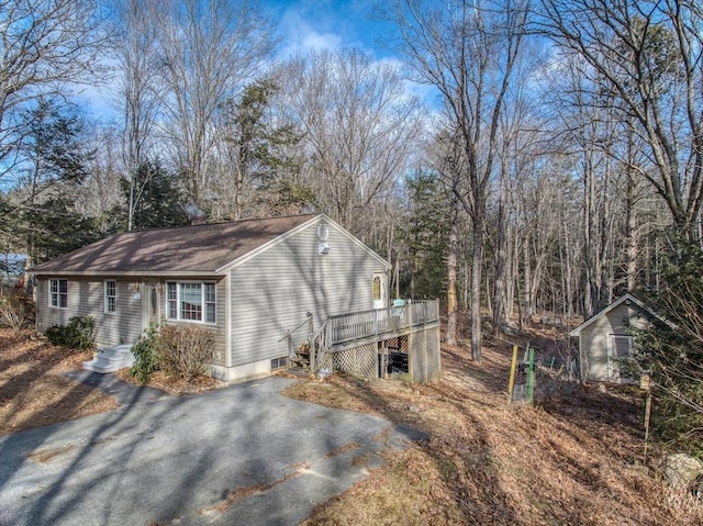 view of home's exterior with a wooden deck