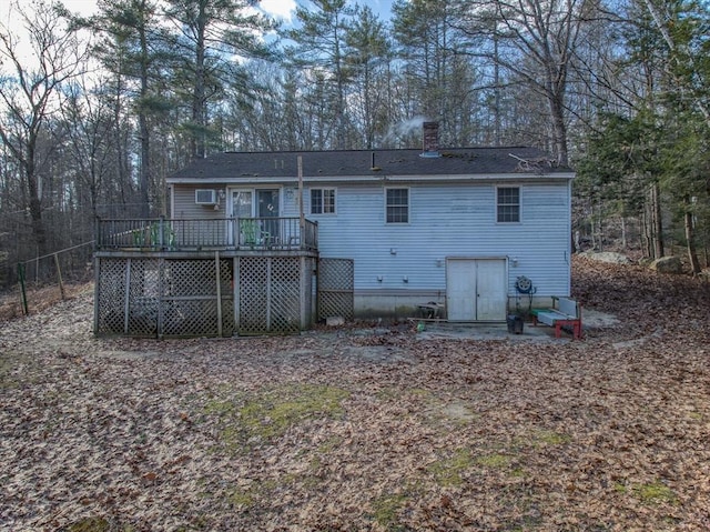 rear view of house featuring a wooden deck