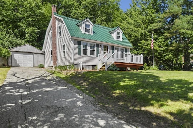 66 Squantum Rd, Jaffrey, NH 03452 - view of front of property featuring asphalt driveway, an outdoor structure, a garage, a front lawn, and a metal roof
