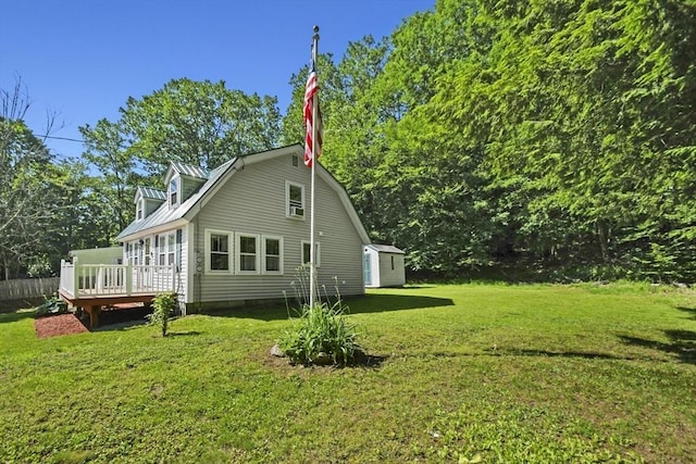 66 Squantum Rd, Jaffrey, NH 03452 - view of home's exterior with a deck, a lawn, a storage unit, a metal roof, and a gambrel roof