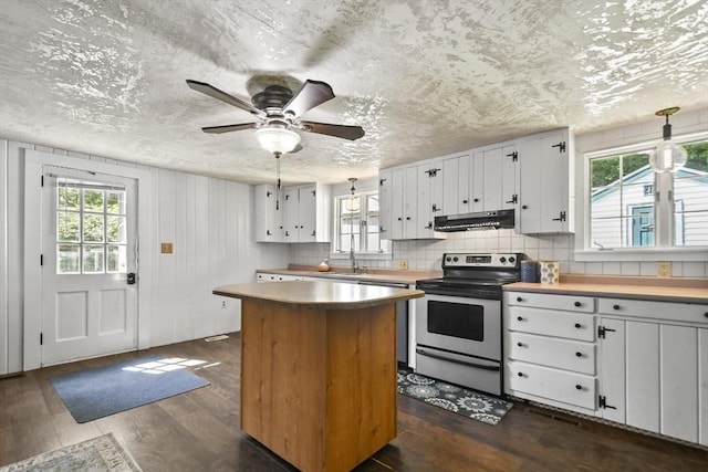 66 Squantum Rd, Jaffrey, NH 03452 - kitchen featuring stainless steel electric range oven, under cabinet range hood, dark wood-type flooring, white cabinetry, and a center island