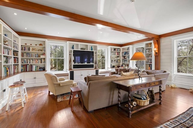 living room with beam ceiling, built in shelves, and hardwood / wood-style flooring