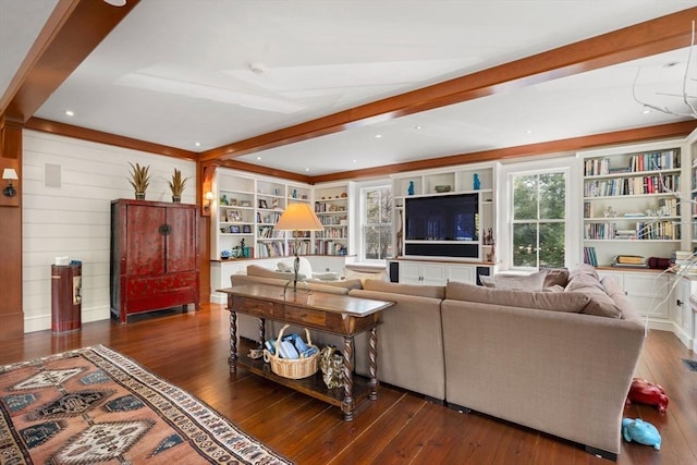 living area featuring beam ceiling, built in shelves, and wood-type flooring