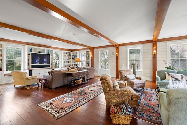 living area with beamed ceiling, built in shelves, and wood-type flooring