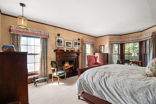 bedroom with multiple windows, carpet, a warm lit fireplace, and ornamental molding