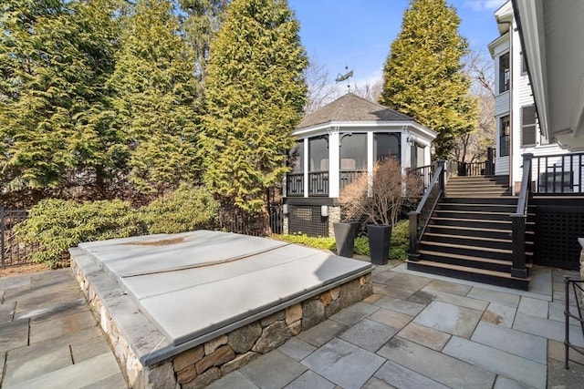 view of patio featuring stairs and a sunroom