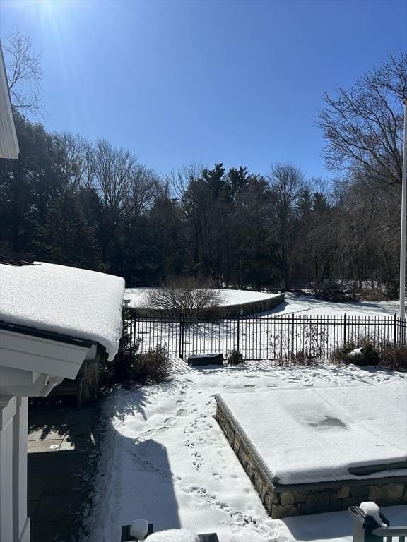 snow covered deck featuring fence