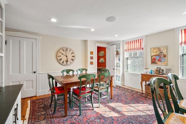 dining area with recessed lighting, light wood-type flooring, and wainscoting