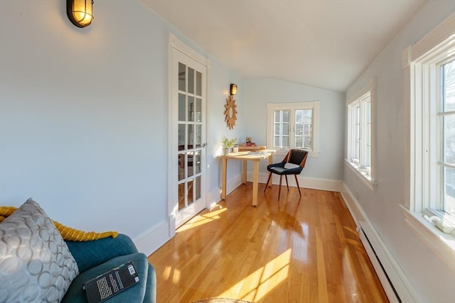 sunroom / solarium with baseboard heating, vaulted ceiling, and a wealth of natural light