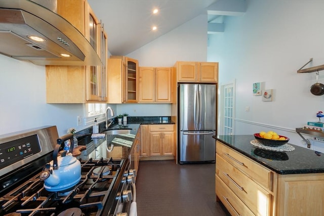 kitchen featuring light brown cabinetry, premium range hood, sink, dark stone countertops, and stainless steel appliances