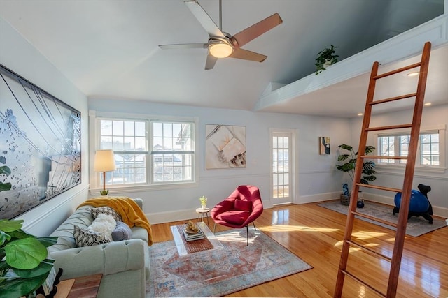 interior space with ceiling fan, hardwood / wood-style floors, and vaulted ceiling