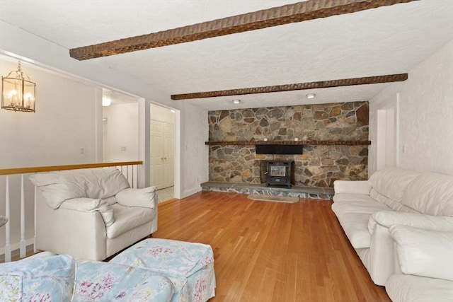 12 Queens Cir, Sharon, MA 02067 - living room with beamed ceiling, wood finished floors, and a chandelier