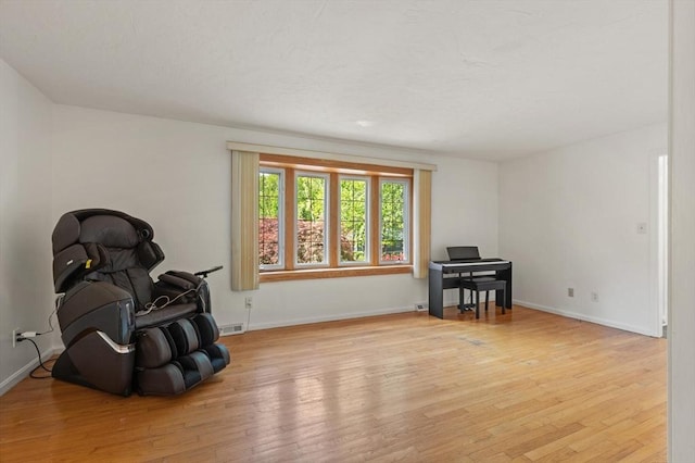 12 Queens Cir, Sharon, MA 02067 - sitting room with light wood-style floors and baseboards