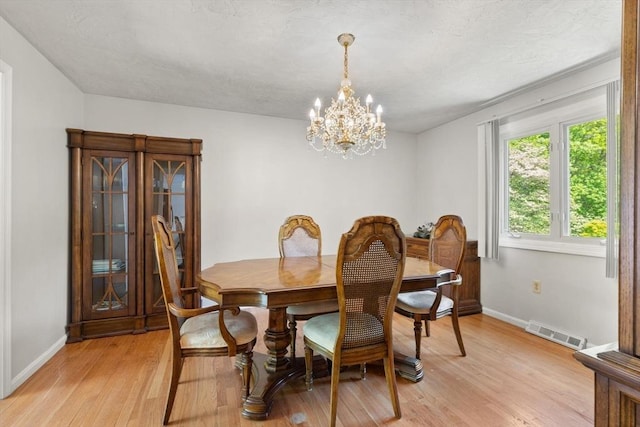12 Queens Cir, Sharon, MA 02067 - dining room featuring baseboards, light wood-style floors, and a chandelier