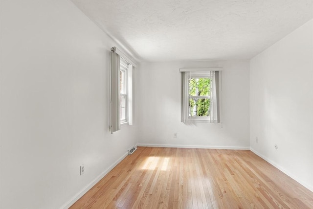 12 Queens Cir, Sharon, MA 02067 - unfurnished room featuring light wood-style flooring, baseboards, and a textured ceiling