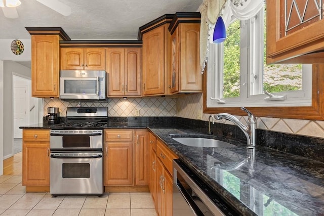 12 Queens Cir, Sharon, MA 02067 - kitchen featuring stainless steel appliances, a sink, light tile patterned floors, dark stone countertops, and a textured ceiling
