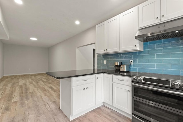 12 Queens Cir, Sharon, MA 02067 - kitchen featuring under cabinet range hood, range with two ovens, a peninsula, light wood finished floors, and white cabinetry