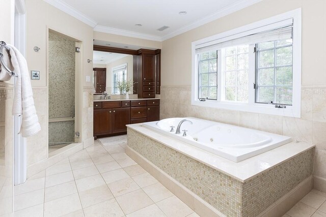 full bath featuring ornamental molding, a shower stall, vanity, a tub with jets, and tile patterned floors