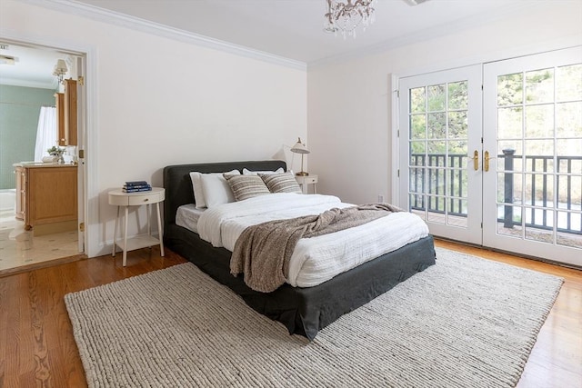 bedroom with access to exterior, multiple windows, crown molding, and wood finished floors