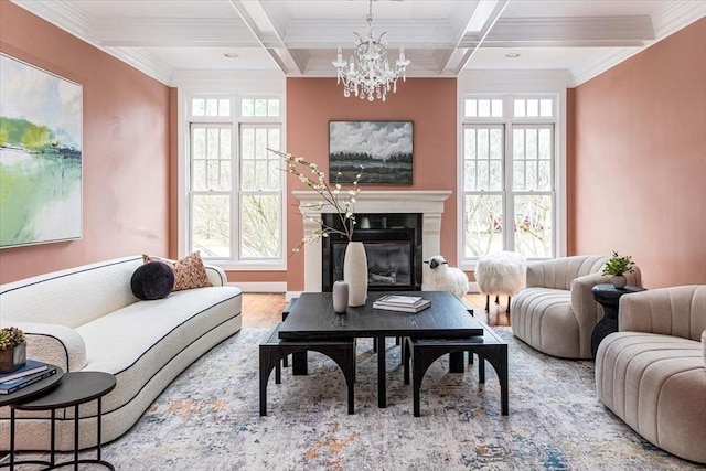 living room featuring wood finished floors, beamed ceiling, coffered ceiling, and a glass covered fireplace