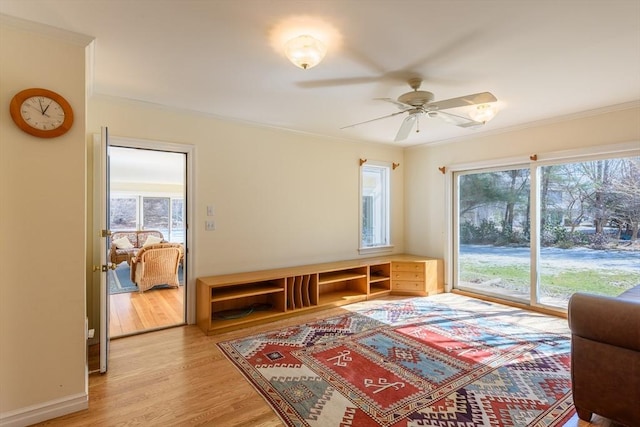 sitting room featuring plenty of natural light, light wood-style flooring, and crown molding