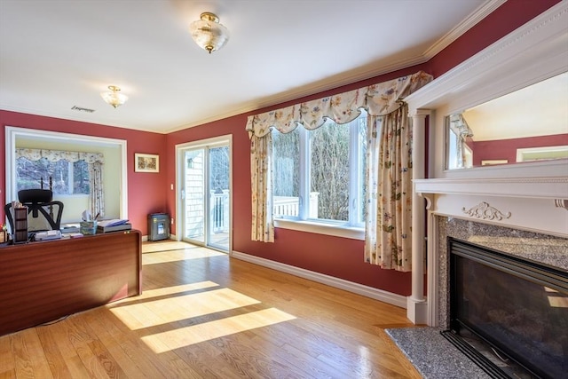 interior space with wood finished floors, baseboards, and ornamental molding