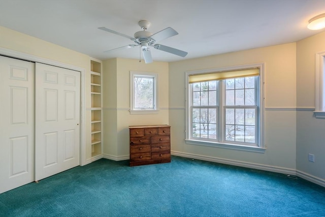 unfurnished bedroom with baseboards, a ceiling fan, and carpet flooring