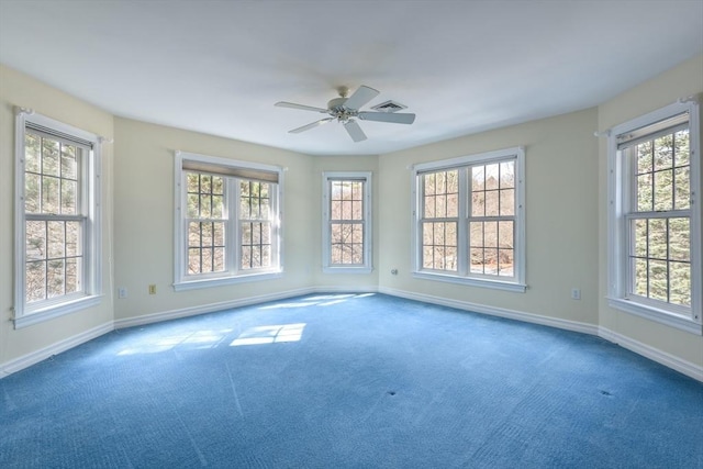 spare room featuring visible vents, baseboards, ceiling fan, and carpet flooring