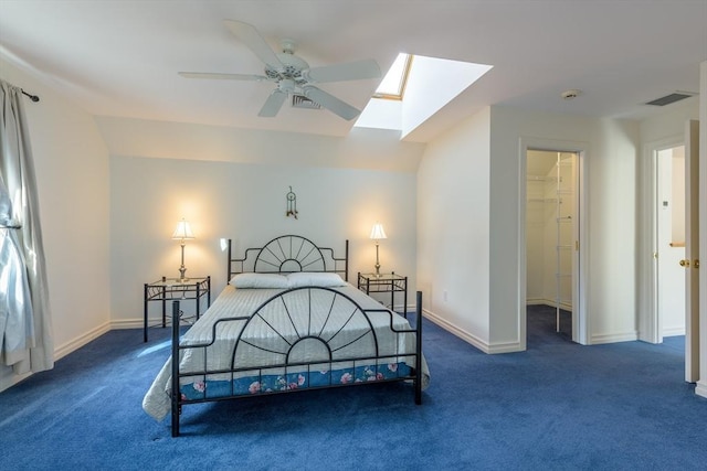 bedroom featuring visible vents, carpet floors, baseboards, and a walk in closet