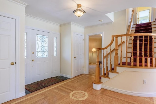 foyer entrance featuring stairway, parquet floors, baseboards, and ornamental molding