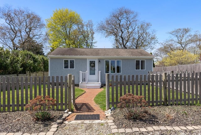 view of front facade with a fenced front yard and a front yard