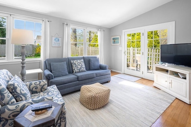 living room with vaulted ceiling and wood finished floors