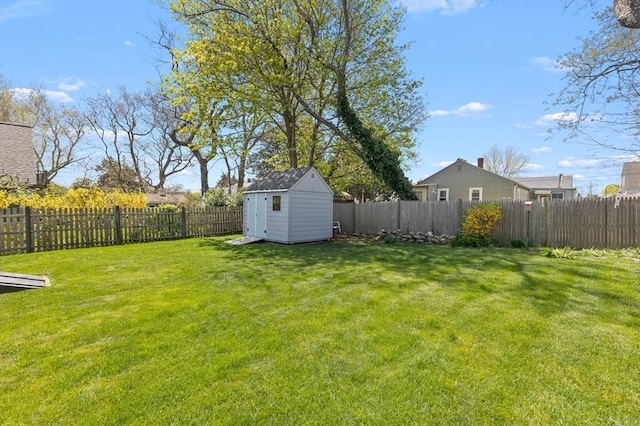 view of yard with a fenced backyard, an outdoor structure, and a shed