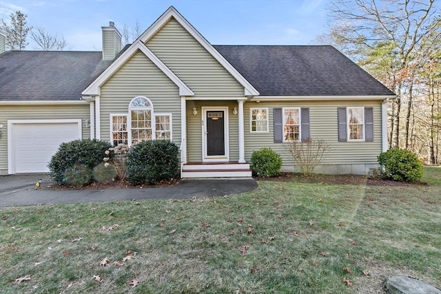 view of front facade featuring a front yard and a garage