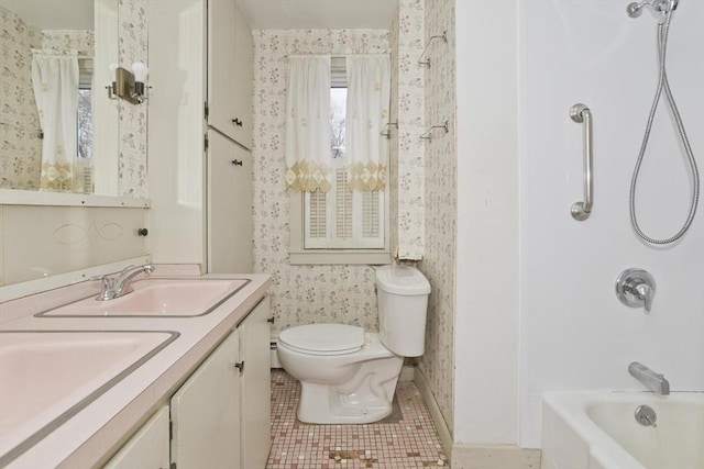 full bathroom with a sink, toilet, tile patterned flooring, and wallpapered walls