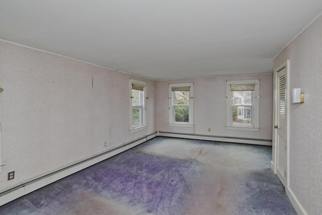 carpeted spare room featuring crown molding and baseboards