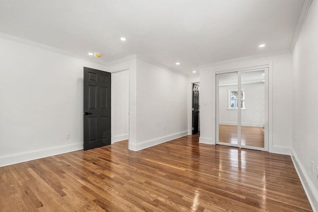 unfurnished room with wood-type flooring and ornamental molding