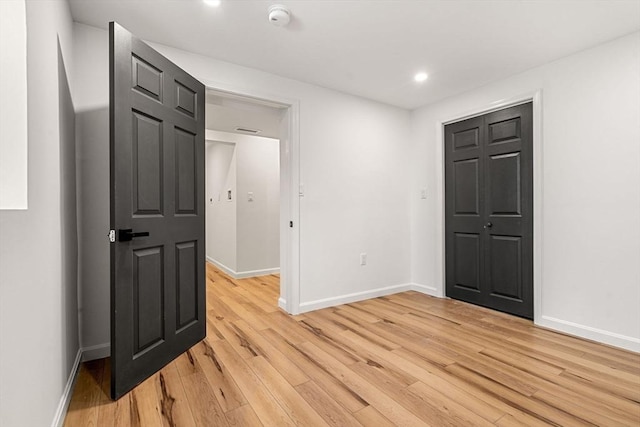 empty room with light hardwood / wood-style flooring