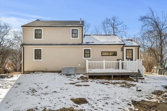 snow covered property with a wooden deck