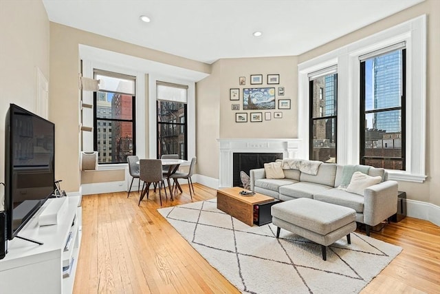 271 Dartmouth St Unit 5C, Boston, MA 02116 - living area featuring light wood-style flooring, healthy amount of natural light, a fireplace, and recessed lighting