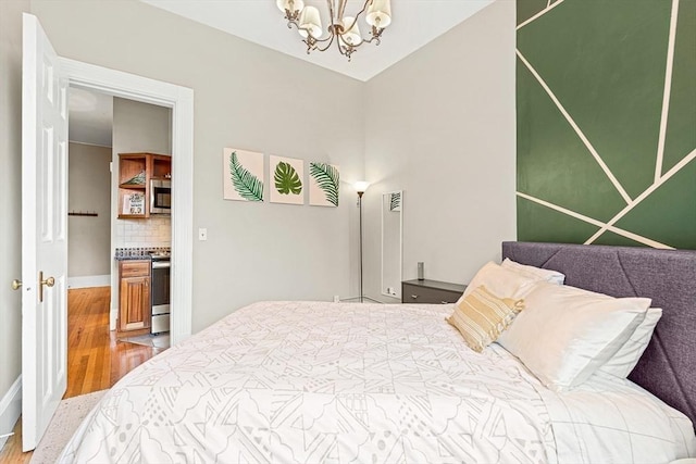 271 Dartmouth St Unit 5C, Boston, MA 02116 - bedroom featuring wood finished floors and a chandelier
