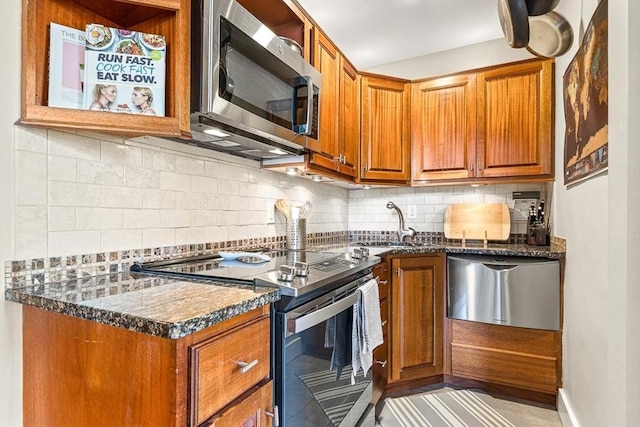 271 Dartmouth St Unit 5C, Boston, MA 02116 - kitchen with appliances with stainless steel finishes, dark countertops, and brown cabinetry