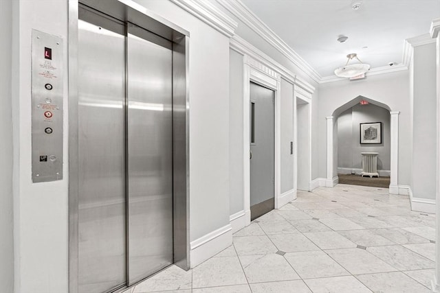 271 Dartmouth St Unit 5C, Boston, MA 02116 - hall featuring elevator, arched walkways, crown molding, light tile patterned floors, and baseboards