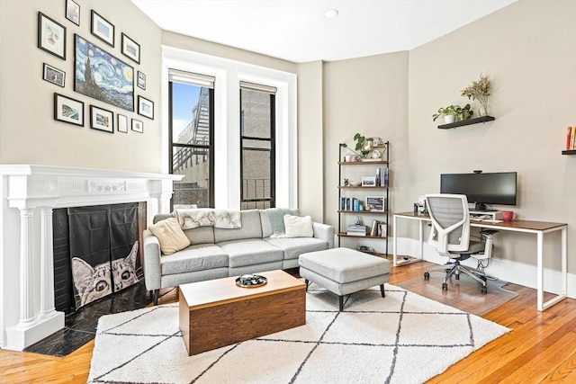 271 Dartmouth St Unit 5C, Boston, MA 02116 - home office with hardwood / wood-style flooring, baseboards, and a fireplace with flush hearth