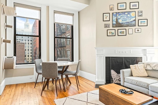 271 Dartmouth St Unit 5C, Boston, MA 02116 - living area with baseboards, hardwood / wood-style floors, healthy amount of natural light, and a fireplace with flush hearth