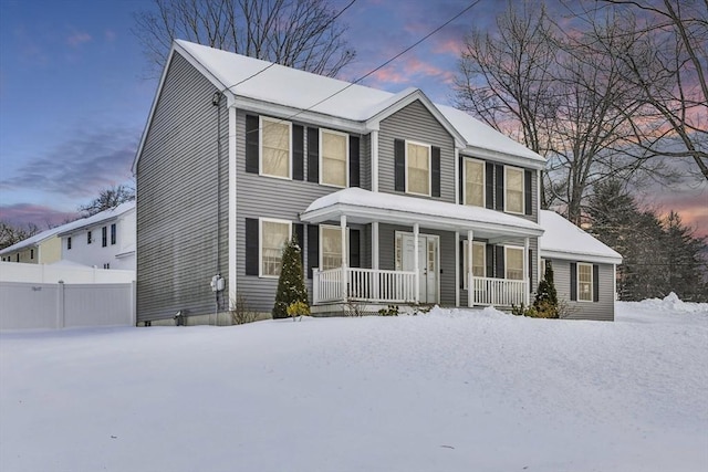 colonial inspired home with covered porch and fence