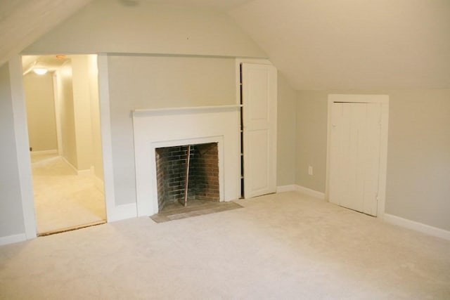 unfurnished living room featuring light carpet and vaulted ceiling